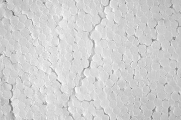 Unique texture of circular white patterns on a flat surface featuring foam