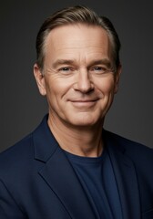 Fototapeta premium Portrait of a Smiling Middle Aged Man in a Navy Jacket