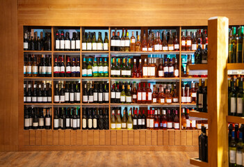 Front view assortment of wine on retail display in liquor store