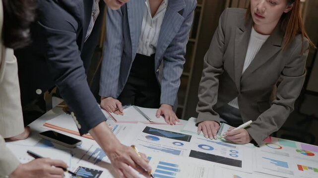 Group of Teamwork businesspeople are meeting working and brainstorming about business financial and marketing on paperwork and presentation data.