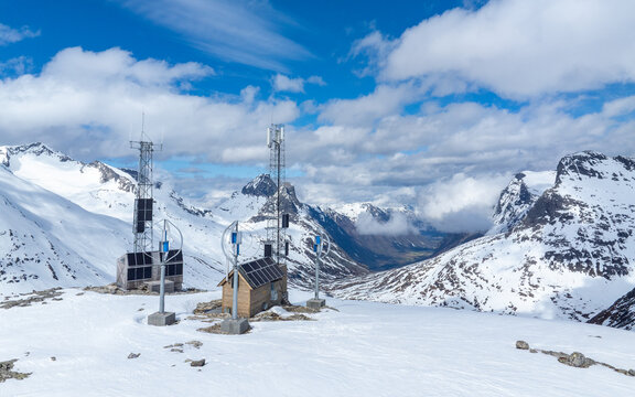 TV and mobile phone mast on top of winter mountain, powered by solar cells and wind turbines. Norwegian mountain landscape not far from Trollstigen.