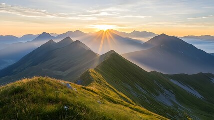 Breathtaking panoramic view of a vast mountain range with golden sunrise illuminating the rugged peaks surrounded by soft mist filling the valleys below in a serene and atmospheric natural landscape
