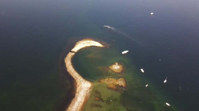 Aerial drone view of Munkholmen (Monk's islet) island surrounded by tranquil waters with boats