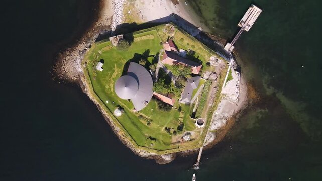 Aerial drone view of Munkholmen island (Monk's islet) surrounded by tranquil waters with boats
