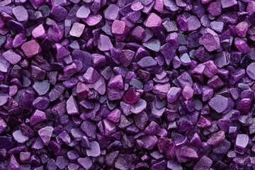 Fototapeta premium A close-up shot of many small, sparkly purple glass pieces creates a textured background Perfect for design projects or crafting