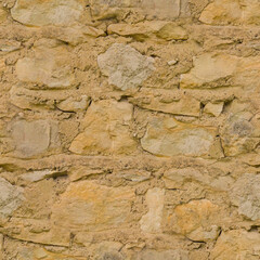 The old yellow stone wall. Yellow stone background. Stone texture.