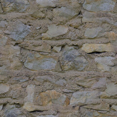 An old, gray stone wall. Grey, stone background. Stone texture. Seamless image.
