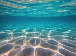 Vibrant underwater abstraction showcasing shimmering light reflections on sandy ocean floor