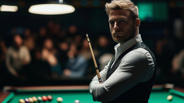 Confident male snooker player in formal attire standing with cue near table in front of blurred audience before tournament match