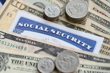 American US dollars money bills, social security number card and on American flag