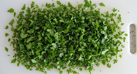 Fototapeta premium Finely Chopped Fresh Parsley on White Cutting Board