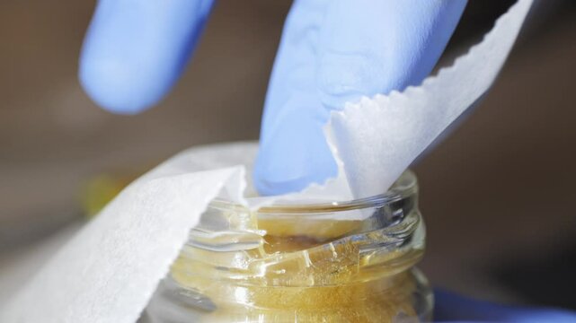 Freshly pressed medical CBD cannabis, hash, live rosin, close-up. Concentrate or cannabis oil obtained by heat-pressing fresh marijuana auto-flowering plants. Packing and Storage of CBD isolate