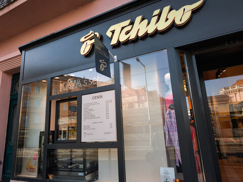 Prague, Czech republic - April 17, 2025: Tchibo coffee shop window displaying clothing and menu take away in prague