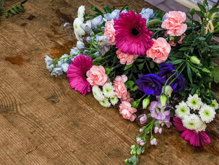 Colorful bouquet lying on rustic wooden table