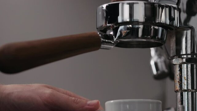 Slow motion low angle shot man making espresso with coffee machine