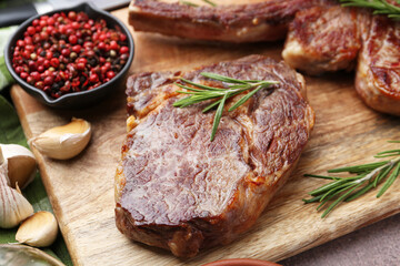 Pieces of delicious beef meat and spices on table, closeup