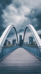 Obraz premium Modern arched bridge spans cityscape under a dramatic sky.