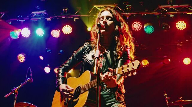 Singer performing passionately on stage with colorful lights  