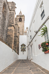 a cobbled street with a view to the church in Vejer de la Frontera, comarca of La Janda, province of Cádiz, Andalusia, Spain