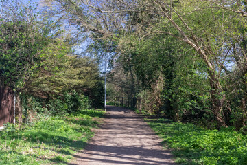 Pathway parallel to the Prittle Brook Greenway, Leigh-on-Sea, Essex, England, United Kingdom, on a sunny spring day.