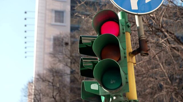 the traffic light in the city is red but turns green

