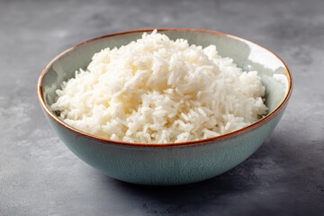 Bowl of rice looks appetizing and delicious. Simple food composition with fluffy white rice, culinary staple that evokes sense of comfort and wholesome goodness