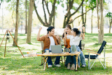 Happy parents and daughter Bakery and Bread Fruit enjoy  in a sunny garden. A joyful summer picnic...