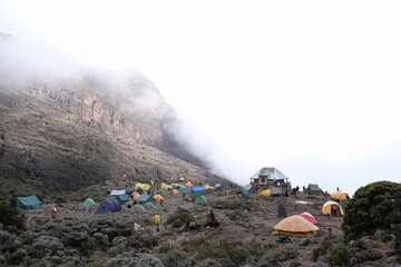 Misty scenery of Barranco Camp with tents on trail to Kilimanjaro Peak, Machame Route, Tanzania
