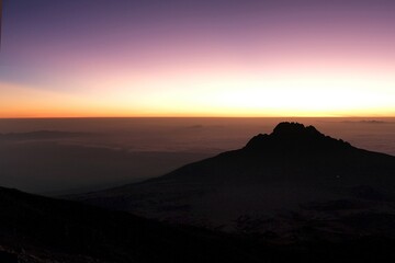 Sunset scenery with Mawenzi Peak on horizon during climbing to Uhuru peak on Kibo volcano (Kilimanjaro) &ndash; 5895 m. Tanzania