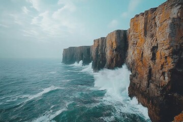 Ocean waves crashing against dramatic cliffs in a cloudy day