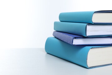 Stack of colorful books on white background