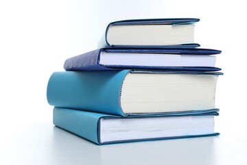 Stack of colorful books on white background