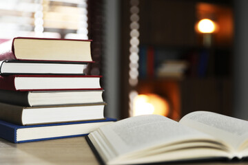 Fototapeta premium Many different books on table against blurred background. Space for text