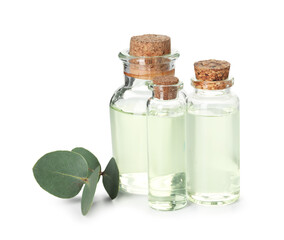 Bottles of essential oil and eucalyptus leaves isolated on white