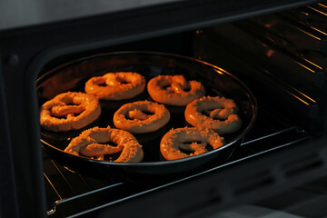 Baking dish with pretzels in oven, closeup