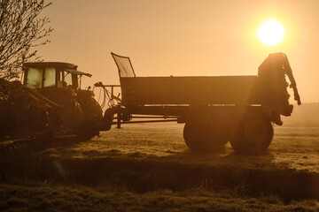 Fototapeta premium Misty Sunrise Over Tractor in Wormer, Low Holland Farmland Scene