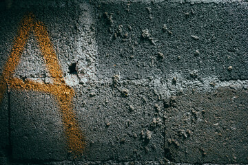 Letter A spray painted on a rustic wall