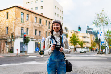 Fototapeta premium Woman photographer with dslr camera taking pictures outdoors. Girl with camera outdoors. Home hobby, lifestyle.