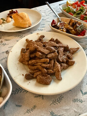 Traditional Turkish food ciger with onion, tomatoes and green pepper. Ciger made with beef liver. Beef liver marinated with milk and cooked in oil. Traditional street food in Turkey.