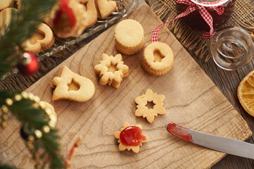 Homemade Linzer Christmas cookies being filled with marmalade