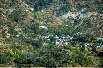 Mountains covered in green trees are home to small towns with charming homes. The multi-layered...