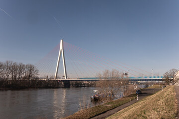 Modern cable-stayed bridge across the river Rhine near Neuwied under blue sky