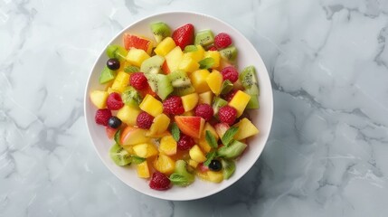 Top-down view of a colorful fruit salad in a white bowl