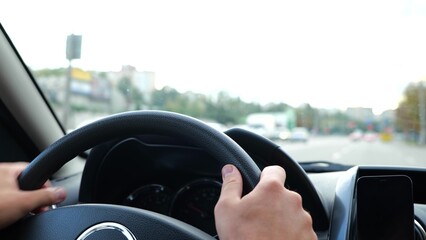 Close up of man hands on steering wheel. Slow motion. Male driving a car on road spinning wheel....