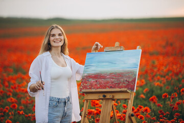 Woman painter painting poppies field en plein air on canvas