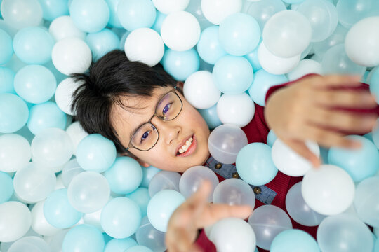 Kids having fun in colorful indoor ball pit