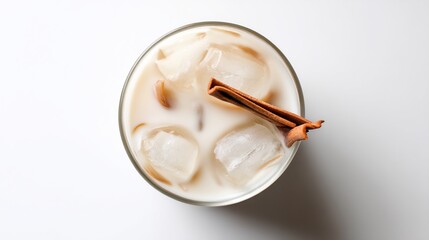 Classic Spain summer cold drink horchata de chufa glass with ice tigernut milk traditional Valencian beverage refreshing drink with minimal white background in top down view