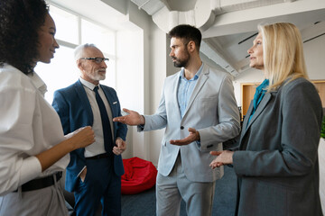 Business team discussing strategy in modern office environment