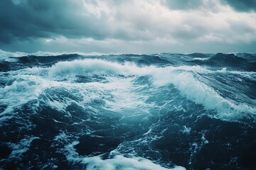 Dramatic Blue Ocean Waves Crashing Under A Dark Cloudy Sky Creating A Turbulent Sea