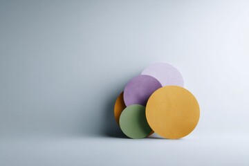 minimalistic image of various colorful circles on clean neutral background featuring ample copy space